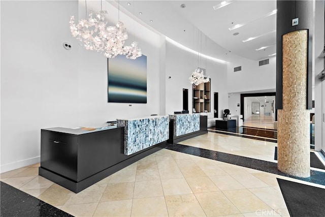 reception area with an inviting chandelier and visible vents
