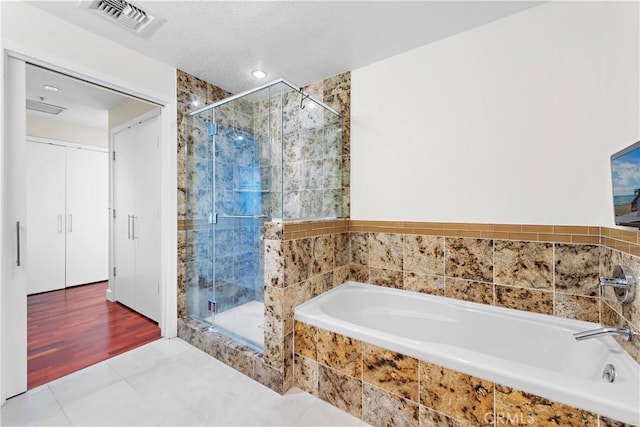 full bathroom with recessed lighting, visible vents, a shower stall, and a bath