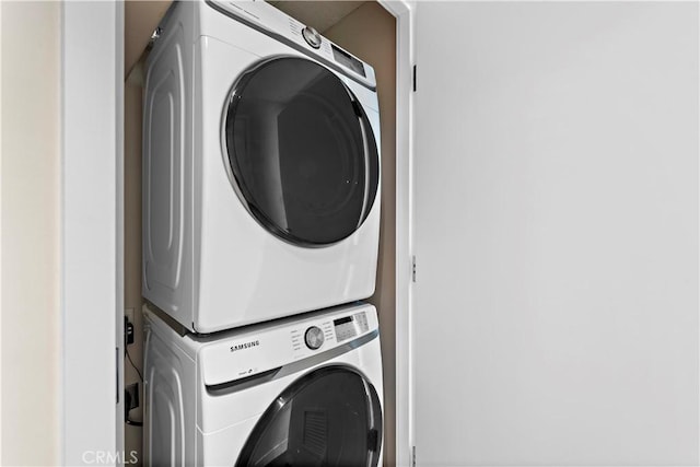 laundry room featuring laundry area and stacked washer and clothes dryer