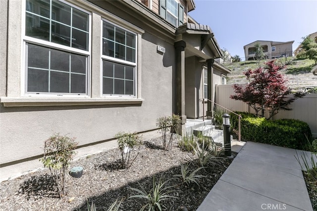 27488 Ginger Ct, Saugus, CA 91350 - view of property exterior featuring a patio area, stucco siding, and fence