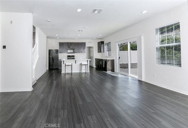 27488 Ginger Ct, Saugus, CA 91350 - unfurnished living room featuring baseboards, dark wood-style flooring, recessed lighting, and visible vents