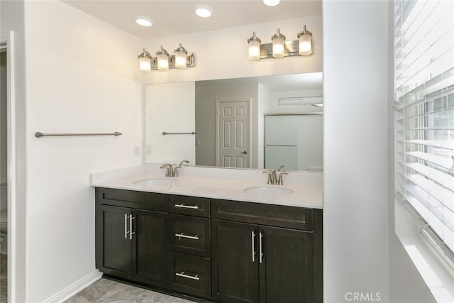 27488 Ginger Ct, Saugus, CA 91350 - full bath featuring recessed lighting, double vanity, baseboards, and a sink