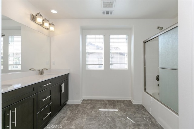 27488 Ginger Ct, Saugus, CA 91350 - full bath with double vanity, enclosed tub / shower combo, a sink, visible vents, and baseboards