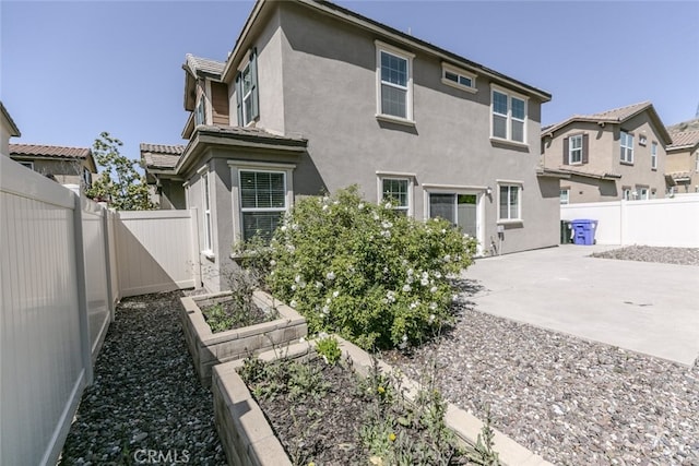 27488 Ginger Ct, Saugus, CA 91350 - rear view of property with a patio area, stucco siding, a vegetable garden, and a fenced backyard
