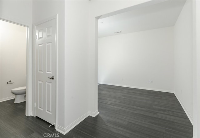 27488 Ginger Ct, Saugus, CA 91350 - corridor with baseboards, dark wood-style flooring, and visible vents