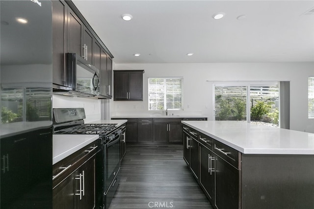 27488 Ginger Ct, Saugus, CA 91350 - kitchen with a sink, black appliances, recessed lighting, light countertops, and dark wood-style floors