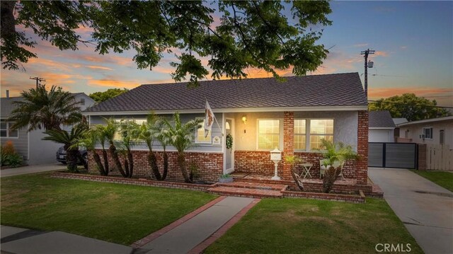2151 Fanwood Ave, Long Beach, CA 90815 - view of front facade featuring covered porch, a lawn, stucco siding, and a garage