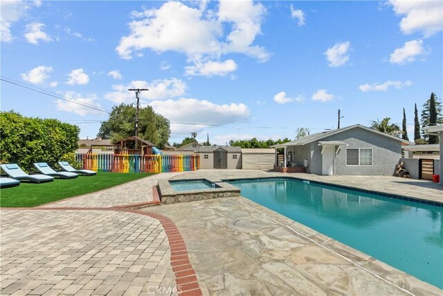17321 Lahey St, Granada Hills, CA 91344 - view of pool featuring fence, a storage unit, a patio area, a playground, and an outdoor structure