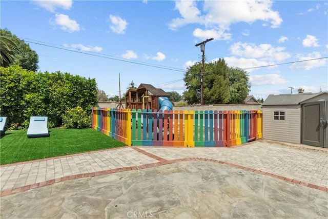 17321 Lahey St, Granada Hills, CA 91344 - view of patio / terrace with fence, an outbuilding, a playground, and a storage unit