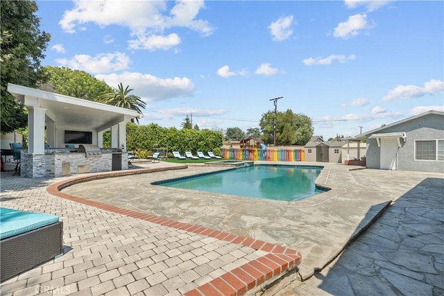 17321 Lahey St, Granada Hills, CA 91344 - view of swimming pool featuring exterior kitchen, a patio area, a fenced in pool, a playground, and a storage unit