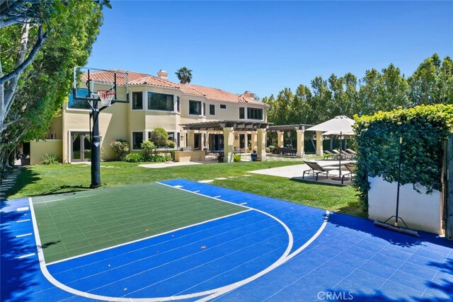 view of sport court with a lawn, a pergola, and basketball hoop
