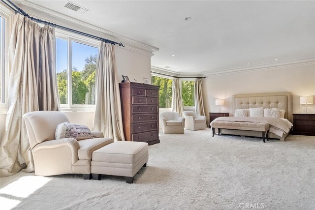 carpeted bedroom with crown molding, multiple windows, and visible vents