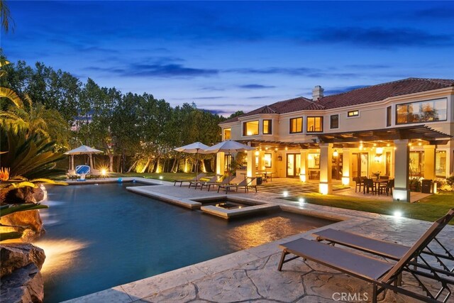 view of pool featuring a patio and a pool with connected hot tub
