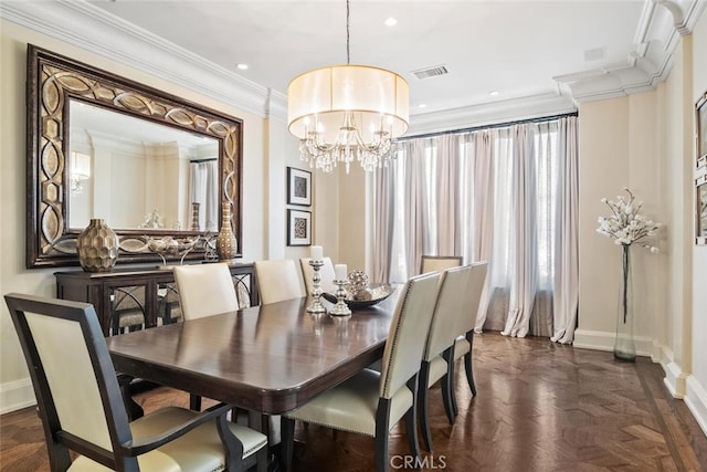 dining space featuring an inviting chandelier, baseboards, crown molding, and visible vents