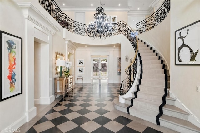 foyer entrance featuring crown molding, an inviting chandelier, baseboards, stairway, and french doors