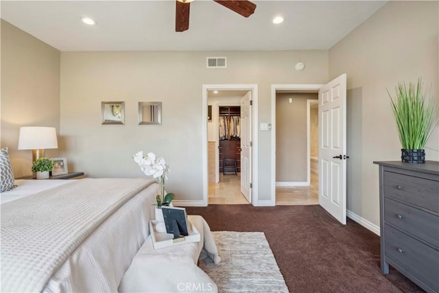 carpeted bedroom featuring baseboards, recessed lighting, a spacious closet, and visible vents