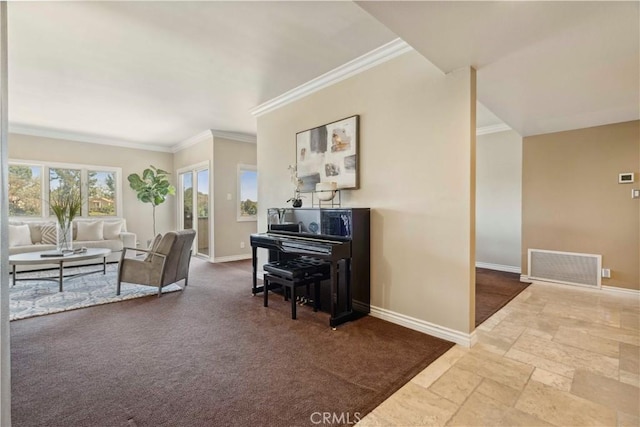 living area featuring crown molding, baseboards, stone tile flooring, and visible vents
