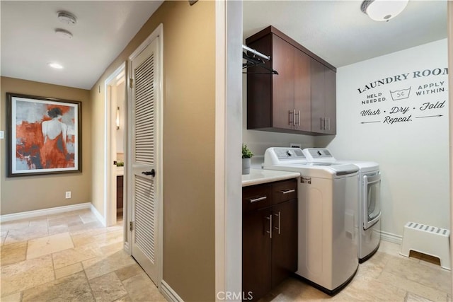 laundry room with stone tile flooring, cabinet space, independent washer and dryer, and baseboards
