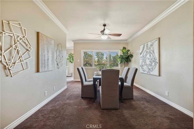 carpeted dining area with crown molding, baseboards, and ceiling fan