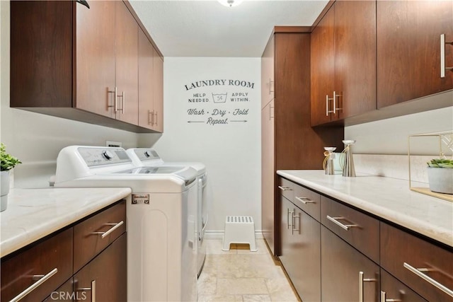 laundry area featuring baseboards, independent washer and dryer, and cabinet space
