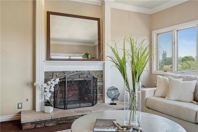 living room with ornamental molding and a fireplace