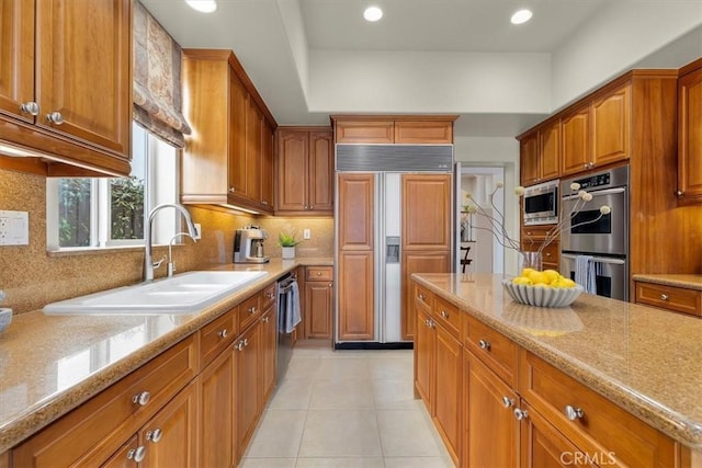 519 S Lucia Ave, Redondo Beach, CA 90277 - kitchen with a sink, decorative backsplash, built in appliances, and brown cabinets