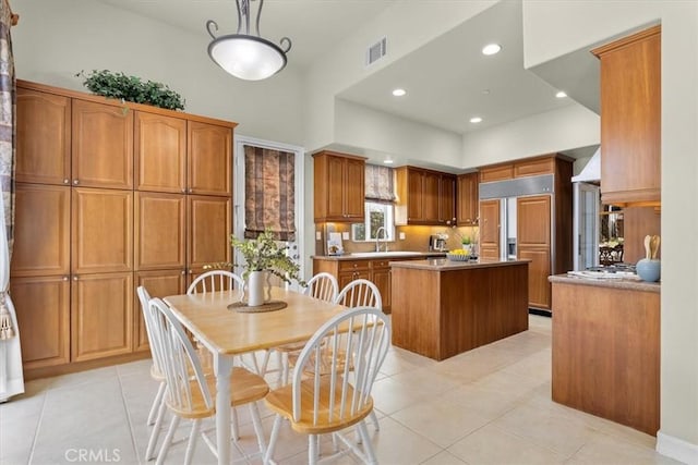 519 S Lucia Ave, Redondo Beach, CA 90277 - kitchen featuring a kitchen island, visible vents, brown cabinetry, and light tile patterned floors