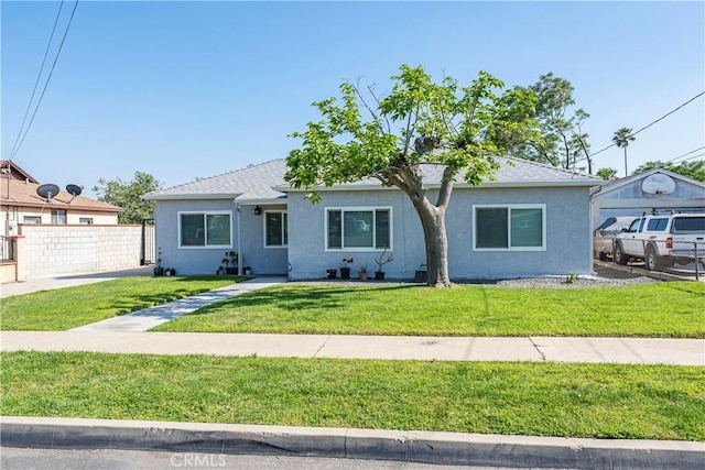 view of front of property featuring stucco siding and roof with shingles