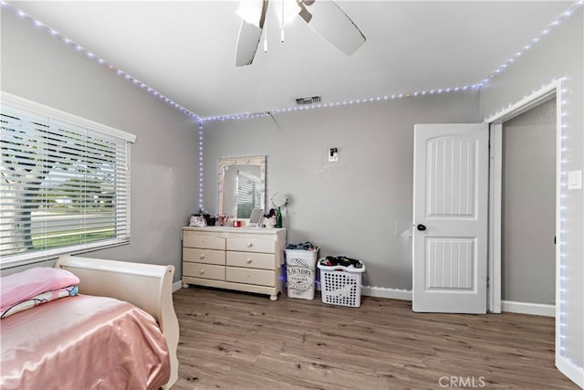 bedroom featuring wood finished floors and baseboards