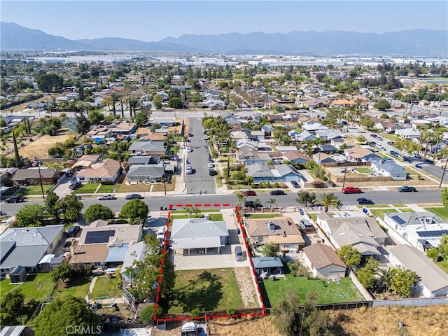 aerial view of residential area with a mountainous background and property boundaries highlighted