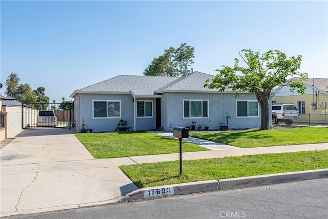 ranch-style home with concrete driveway, stucco siding, a gate, and a shingled roof