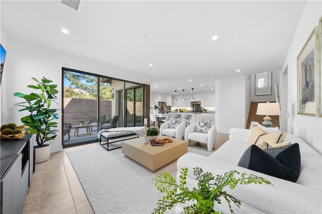 living room with visible vents, recessed lighting, light tile patterned floors, and a wealth of natural light