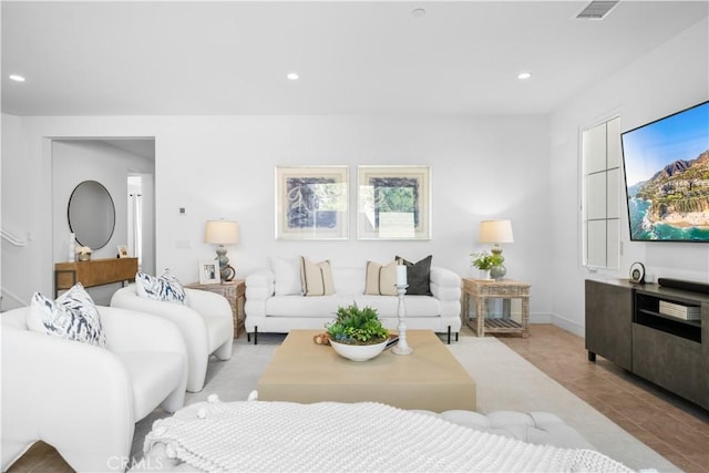 living room featuring recessed lighting and visible vents