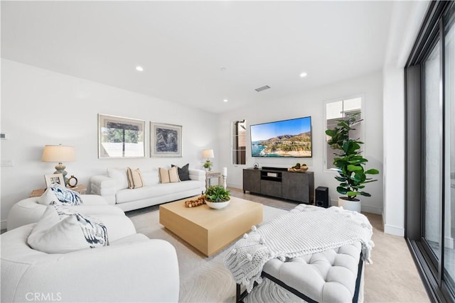 living area featuring baseboards and recessed lighting