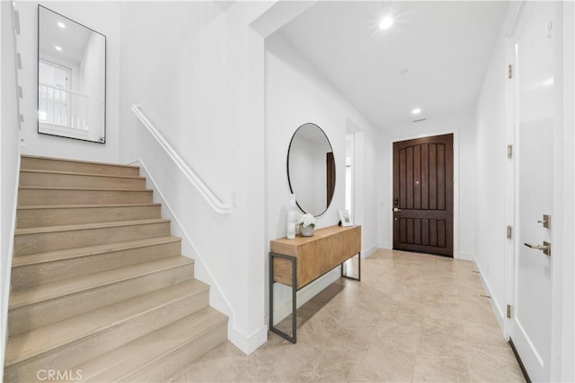 foyer with recessed lighting, baseboards, and stairs