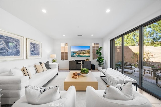 living room featuring recessed lighting, a healthy amount of sunlight, and visible vents