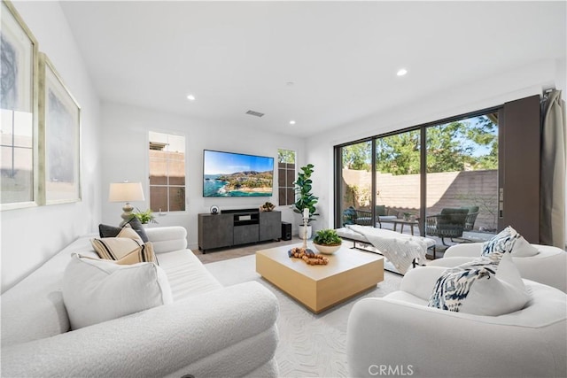 living area with recessed lighting and visible vents