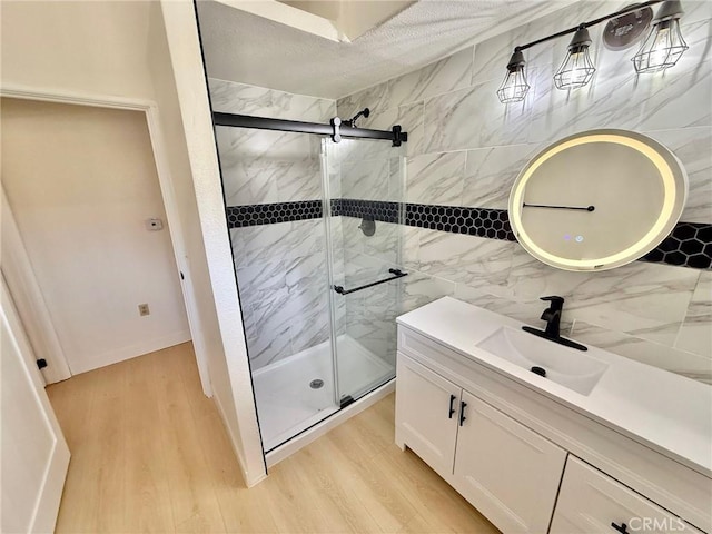 14721 Voltaire Dr, Pine Mountain Club, CA 93225 - full bath with wood finished floors, a stall shower, tasteful backsplash, and vanity