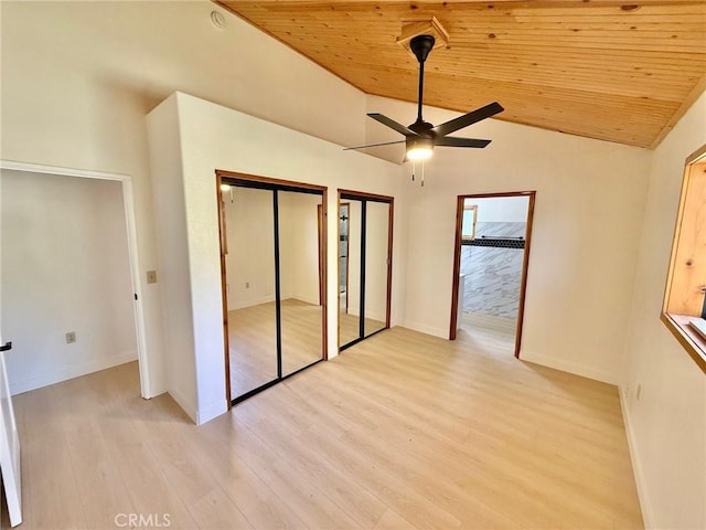 14721 Voltaire Dr, Pine Mountain Club, CA 93225 - unfurnished bedroom with wood ceiling, vaulted ceiling, baseboards, multiple closets, and light wood-style flooring