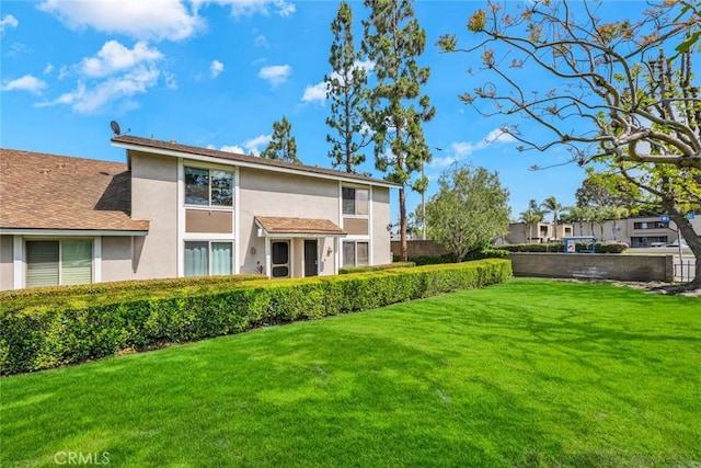 6702 Sun Dr Unit C, Huntington Beach, CA 92647 - rear view of house featuring a lawn and stucco siding