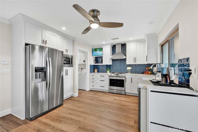 6702 Sun Dr Unit C, Huntington Beach, CA 92647 - kitchen with wall chimney range hood, crown molding, appliances with stainless steel finishes, and a sink