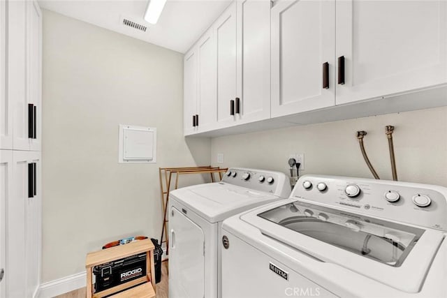 6702 Sun Dr Unit C, Huntington Beach, CA 92647 - laundry room featuring visible vents, baseboards, light wood-style floors, washer and clothes dryer, and cabinet space