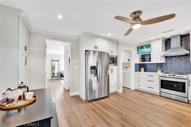 6702 Sun Dr Unit C, Huntington Beach, CA 92647 - kitchen with visible vents, ceiling fan, wall chimney exhaust hood, white cabinetry, and appliances with stainless steel finishes