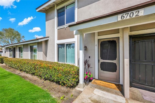 6702 Sun Dr Unit C, Huntington Beach, CA 92647 - doorway to property featuring stucco siding