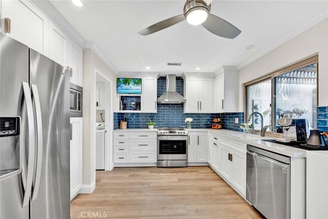 6702 Sun Dr Unit C, Huntington Beach, CA 92647 - kitchen featuring a ceiling fan, ornamental molding, wall chimney exhaust hood, a sink, and stainless steel appliances