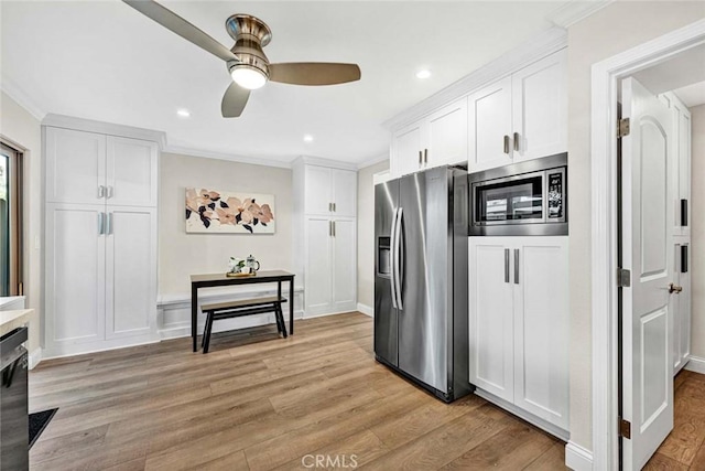 6702 Sun Dr Unit C, Huntington Beach, CA 92647 - kitchen featuring white cabinets, a ceiling fan, stainless steel appliances, and ornamental molding