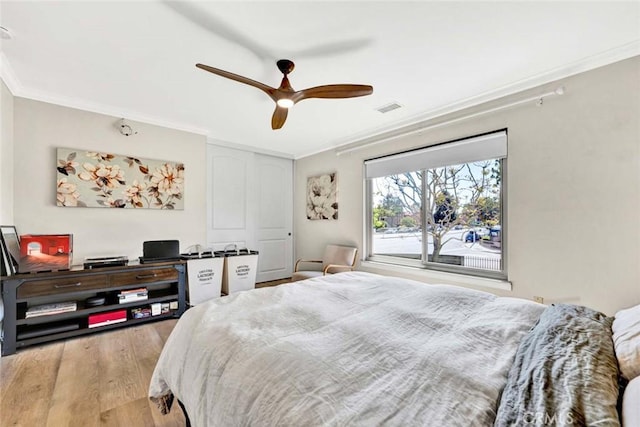 6702 Sun Dr Unit C, Huntington Beach, CA 92647 - bedroom with ornamental molding, a ceiling fan, wood finished floors, and visible vents