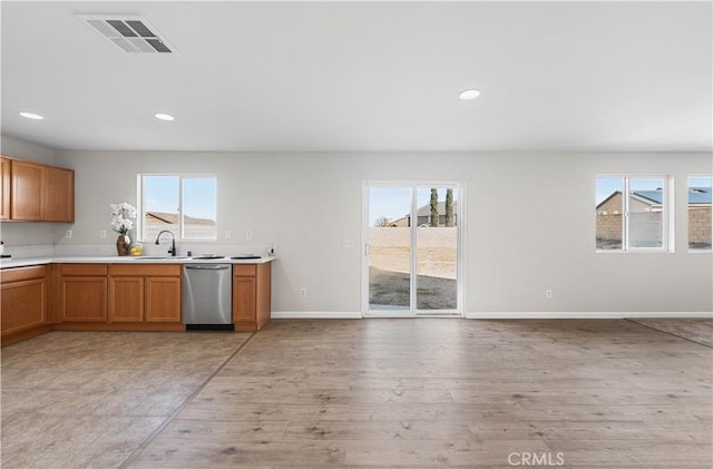 42570 72nd St W, Lancaster, CA 93536 - kitchen with light countertops, baseboards, stainless steel dishwasher, and visible vents