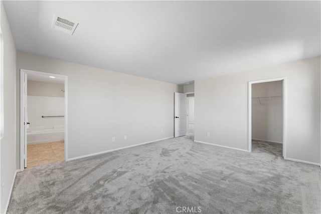 42570 72nd St W, Lancaster, CA 93536 - unfurnished bedroom featuring ensuite bath, carpet, baseboards, a spacious closet, and visible vents