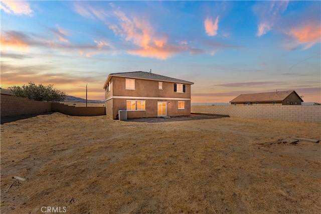 42570 72nd St W, Lancaster, CA 93536 - back of property at dusk with a fenced backyard and stucco siding